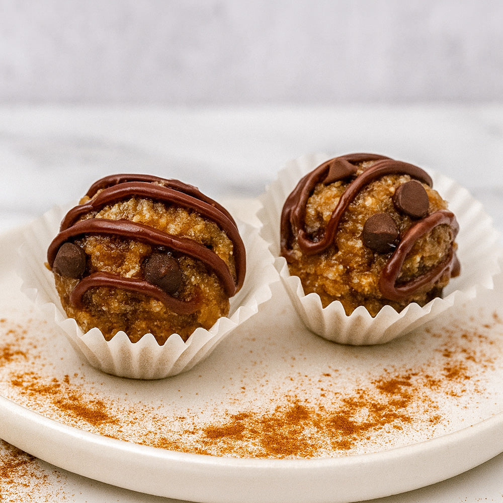 Two chocolate-dipped cookie dough balls on a plate with a white background Sweetgrub Saint Petersburg 