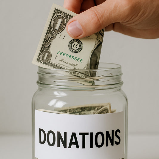 Hand placing money into a donation jar with a clear background