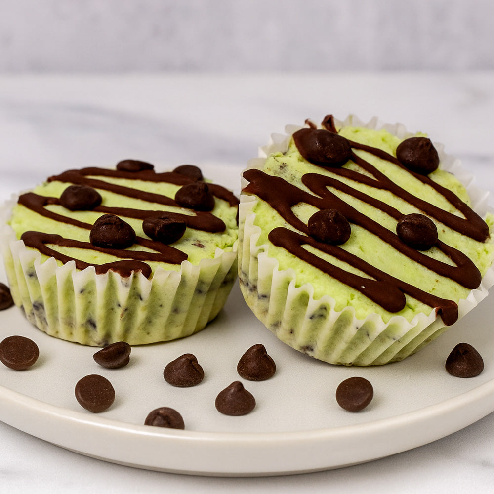 Two mint chocolate chip ice cream cups on a white plate with chocolate drizzle and mini chocolate chips. Mint Brownie Sweetgrub Saint Petersburg 